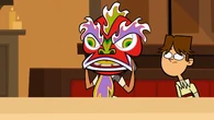 As punishment, Courtney is forced to put on a lion dancer's mask.