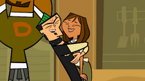 Duncan lifts Courtney up and gives her a big hug to celebrate their team's victory in the cooking challenge.