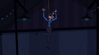 Heather is dangled from the ceiling in a costume of a security guard.