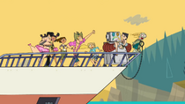 Alejandro (still in his robotic body) holds Heather as the yacht approaches .