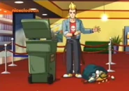 Usher drops the garbage bag so he can comb his hair.