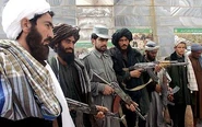 Taliban fighters turning in their weapons