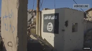 An ISIS flag on the side of a building in Sinjar