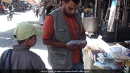 People in Yarmouk Camp reading IS leaflets, 13 June 2016