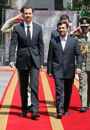 Assad walking with  leader 