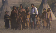Dunbar walking with the tribe in their camp