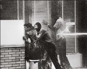 Activists being attacked by a police fire hose during the 