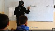 An IS fighter teaching Iraqi students in Rawa, 12 June 2016