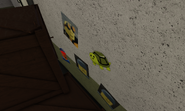 Five emojis in the building behind spawning building. (The emojis are from the discord server)