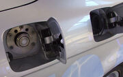 Fill caps on a  automobile for  (left) and for gasoline (right) fuel tanks