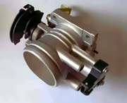 Throttle body showing . The throttle cable attaches to the curved, black portion on the left. The copper-coloured coil visible next to this returns the throttle to its idle position when the pedal is released.