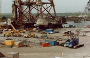 The subsea jacket for a oil platform being loaded onto a transport barge using  units. These units have the ability to be raised and lowered to keep the load verticle as it travels on to the barge that is moving with the tide. To kkep the barge level as the load moves on the water ballast in it is pumped out to balance it and help compensate for the changing river levels over the several hours it takes to move the load on.