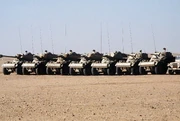 Panhard AML light armoured cars with 90mm guns stand in a holding area during Operation Desert Shield. The equipment is part of the 's arsenal.