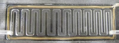 Condensation of water produced by a PEMFC on the air channel wall. The gold wire around the cell ensures the collection of electric current