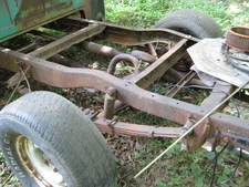  frame. Notice hat-shaped crossmember in the background, c-shape rails and crossmember in center, and a slight arch over the axle.