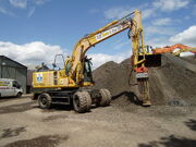 PW130es of SE Davis & Son fitted with a  for breaking oversize material for the crusher