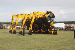 JC Balls Dancing digger team forming arch for drive through