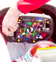 A modern  car's steering wheel has buttons and knobs to control various functions as well as gauges and other important items normally found on a .