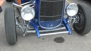 Deuce with chrome dropped tube axle and shocks. Note Model A chassis (extended frame horns), disc brakes, zoomie pipes.