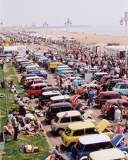 Minis lined up on  seafront after a  