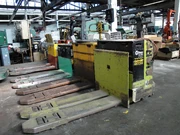An electric pallet jack. The recharging lead can be seen.