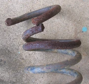 Oxy-cut spring showing deformation due to loss of tempering in adjacent turn