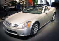 Cadillac XLR c. 2007, with fully retracted aluminum (i.e., lightweight) hardtop concealed by self-storing tonneau cover, the hardtop manufactured by a supplier joint venture of Mercedes-Benz and Porsche.[13]