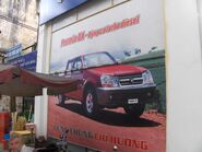 A poster for the PMC Premio DX II at a Mekong Auto dealership in Ho Chi Minh City, Vietnam.