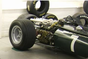 A BRM H16 engine, mounted in the back of a   car.