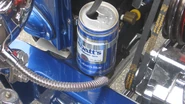 A "puke can" (radiator overflow reservoir)