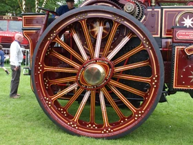 The fine lining and detailing on the rear wheels of this just restored engine
