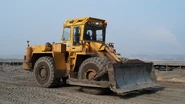 A wheeled bulldozer in an open pit coal mine