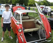 BMW Isetta 600, showing hinged steering wheel, next to 5&nbsp;ft&nbsp;3&nbsp;in (160&nbsp;cm) boy