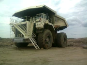 A worker at a mine in Northern Alberta, Canada stands next to a Terex 6800AC "Heavy Hauler"
