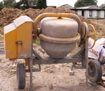 An outdated model of a small-scale concrete mixer. These older mixers are heavy and can not be moved as easily