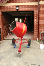 This portable concrete/mortar mixer has  and a towing tongue so that it can be towed by a motor vehicle and moved around the worksite by hand, and its  is powered by .  The lever allows the concrete/mortar to be tipped into a .