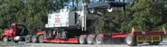 A lowboy trailer carrying a Link-Belt Lattice Crawler crane.