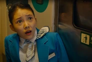 Min-ji horrified as she watches the woman turn into a zombie