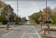 A modern 4-quadrant gate crossing with four signals and four gates in Bloomington, Illinois