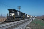 A duo of NS C39-8 units with the lead unit running "long-hood forward" on a mixed freight (a typical fashion used by the Southern Railway).