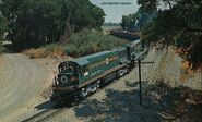 Oro Dam U25C's leading a loaded train towards the Oroville Dam site in 1963-64.