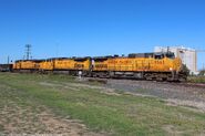 Former SP Dash 9 units leading a UP mineral train.