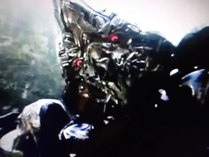 Grimlock, in robot mode, roaring in anger at Optimus Prime.