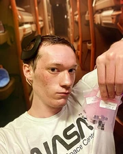 Josh Universe wearing a Brain-Computer Interface and holding micro-electronics