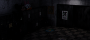 Oswald in the Locker Room. He is close to the camera in front of the lockers on the left, next to the costume heads.