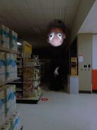 “Moving through the aisles, after the stores have closed" The caption of an image of The Stranger, seen in a dark part of a department store.