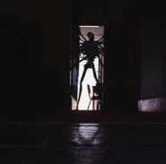 The Angel’s silhouette standing outside a doorway in a school