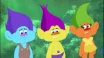 A close-up of three Random Trolls. The middle is one of the 4 possible colors for the random Treasure Troll that is seen from time to time.