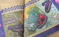 Photograph of the map from the Golden Book adaptations of Trolls World Tour, where Bergen Town can be seen on the bottom left. Note: Pages are difficult to capture due to book layout.