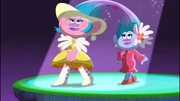 The twins are into fashion and make their own gowns, as well as outfits for other Trolls.
